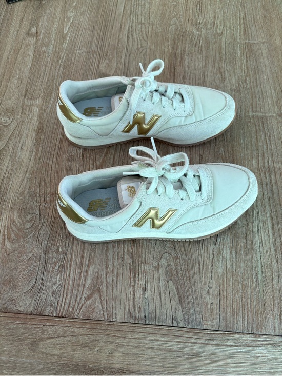New Balance Shoes - New Balance Women's Cream Sneakers with Gold Accents